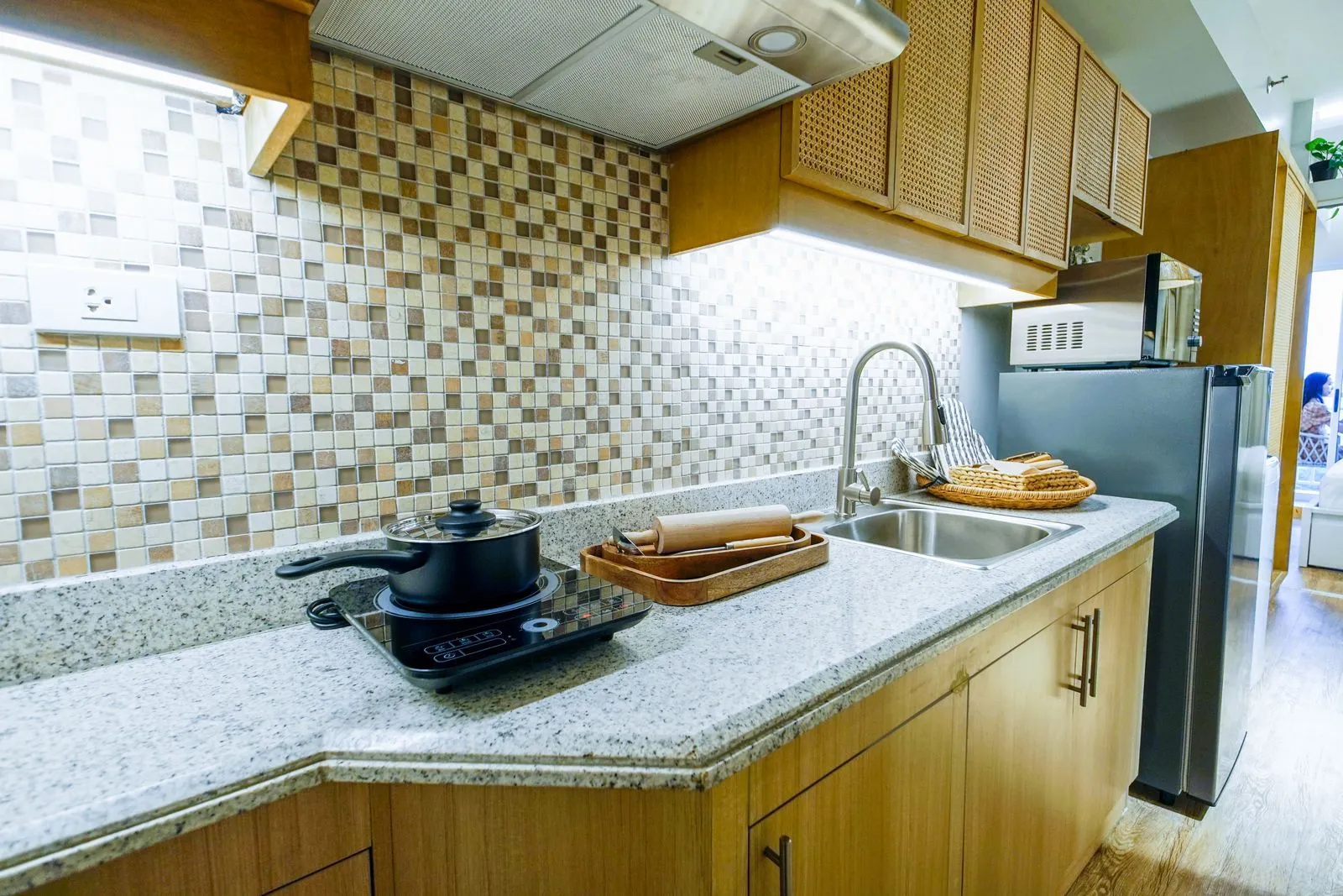 Bright modern kitchen with granite countertop and stainless steel appliances.